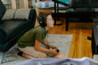 © Jake Jakab/ADDICTIVE STOCK - Concentrated little boy in casual clothes sitting on sofa with crossed legs and playing video game with joystick
