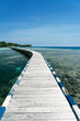 © Javier Ballester/ADDICTIVE STOCK - Long wooden embankment going through clear water of sea on sunny day in summer