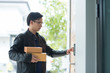 © waranyu - delivery man is ringing the doorbell