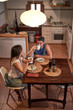 © Philippe Degroote/ADDICTIVE STOCK - From above of loving couple sitting at table in cozy kitchen and eating tasty breakfast in morning while looking at each other