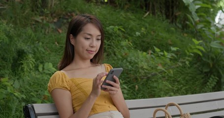 Canvas Print - Woman use of mobile phone and sit at the park