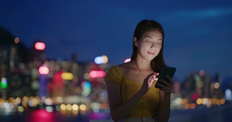 Canvas Print - Woman look at mobile phone in city at night