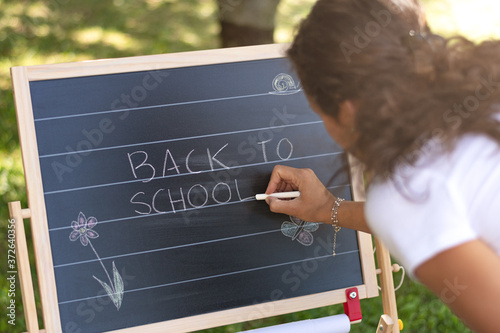 Back to School. Back to School written on classroom chalkboard by teacher. Outdoor classroom.