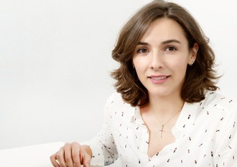 Wall Mural - portrait of young happy woman looks in camera