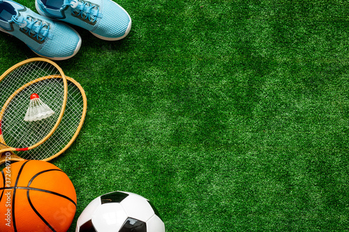 Frame of sport balls - football, basketball on football field. Copy space