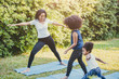 © Quality Stock Arts - Black African American mom with child playing yoga family activity together at backyard during self quarantine at home.