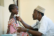 © Hugh Sitton - Doctor examining girl in clinic