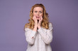 © Viktor Koldunov - Shocked mature woman covers her mouth with hands feeling stressed. Studio shot