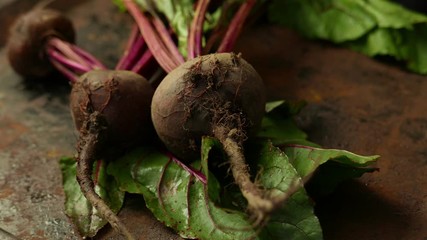 Canvas Print - Beetroots with green haulm on the black rustic background.