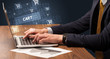 © ra2 studio - Businessman working on laptop with CART inscription, online shopping concept