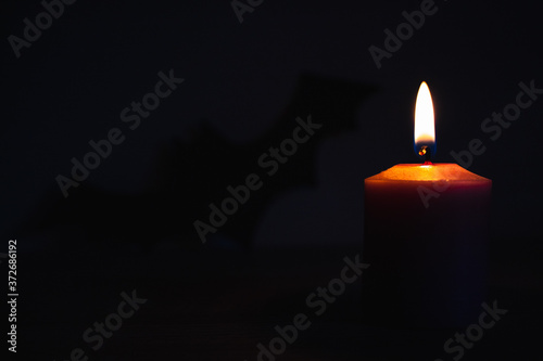 Cuadros en Lienzo burning candles with bat silhouette background