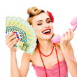 Happy excited woman with half closed eyes, holding money euro cash banknotes, talking on phone, pin up style. Blond girl in retro fashion and vintage studio concept. Isolated over white background.