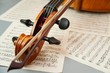 Fragment of a cello or violin with a bow on a background of notes and a place for text