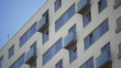 © spocktv - Close up shot of residential building. Close up Of An Apartment Blocks. The building features exterior with small balconies