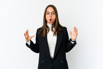 Young mixed race business woman isolated on white background celebrating a victory or success, he is surprised and shocked.