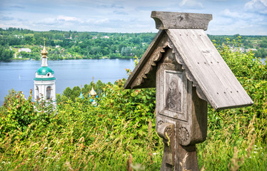 Wall Mural - Wooden cross and the bell tower of the Varvarinskaya church  in Plyos