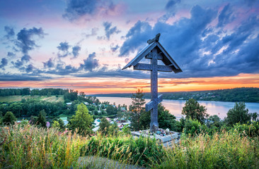 Wall Mural - Mount Levitan in Plyos on a summer evening and a wooden cross of the churchyard.  Inscription: worship cross