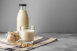© fotofabrika - Vegan oat milk with oat flakes close up