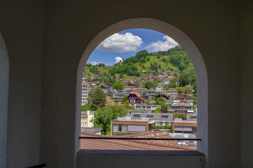 Poster - view through arched windows of the city of Thun in Switzerland