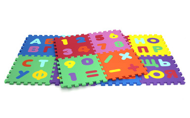 Fototapete - puzzle mat - multicolored soft elements letters and numbers on a white background