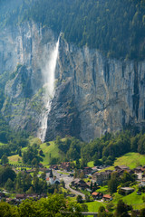 Wall Mural - The Lauterbrunnen Village Church and Staubbach Falls in Lauterbrunnen, Switzerland.