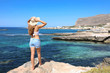 Beautiful traveler girl in Sicily. Young woman enjoying holidays in Favignana Island in Italy.