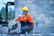 © visoot - Professional mechanic man wearing protective mask to Protect Against Covid-19 is cutting steel metal with rotating carbon blade cutter.