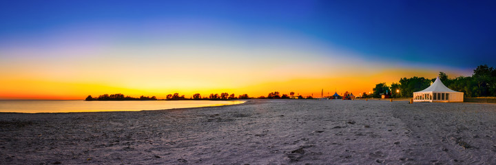 Wall Mural - Sunset at the IJsselmeer with the beach of Makkum