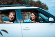 © Erika - Enjoying travel. Beautiful young couple sitting. Love couple. Car. Happy day. Travel concept. Vacation.