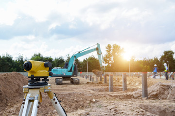 Surveyor equipment tacheometer or theodolite measurement for checking level excavation depth of foundation at construction site.