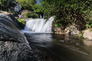 Closeup shot of a waterfall with silky water in the forest
