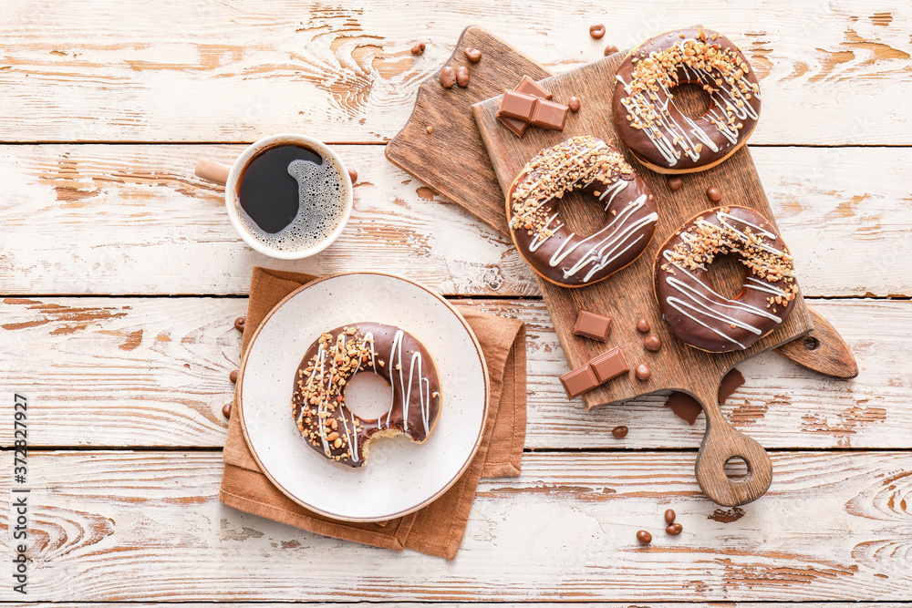 Composition with tasty donuts and coffee on table