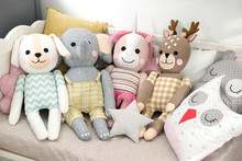 Cute Toys And Pillows On Bed In Baby Room. Interior Elements