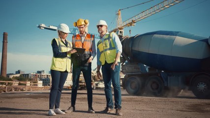 Wall Mural - Diverse Team of Specialists Use Tablet Computer on Construction Site. Real Estate Building Project with Civil Engineer, Architect, Business Investor Discussing Planning and Development Details.