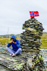 Wall Mural - Tourist with camera in Norway mountains