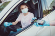 © deagreez - Photo of girl travel ride drive car need entry pay bank card swipe pos terminal wear blue latex rubber gloves medical gloves in town center