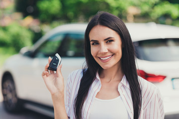 Poster - Close-up portrait of her she nice attractive pretty lovely cute content cheerful cheery lady skilled experienced driver owner near white car loan motor holding in hand electronic lock outdoor outside