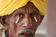 Old Indian man in turban from Rajasthan getting his eyes tested. Schirmer's test. Dry eye test.Testing level of tears in eyes.Eye testing strip. Eye camp.   