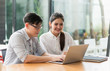 © Nopphon - Asian business people man and woman conference talking and working with laptop together. Young couple work at home.