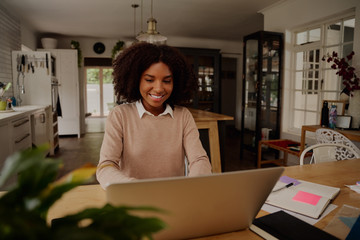 Wall Mural - Successful young businesswoman entrepreneur working on laptop from home office space