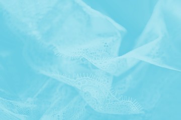 Wall Mural - Delicate pastel silk lace lingerie, flying fabric, light blue color background