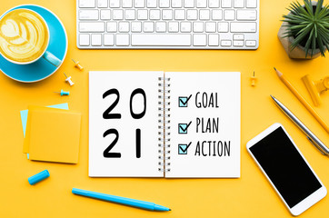 2021 new year goal,plan,action text on notepad with office accessories.Business management,Inspiration concepts