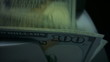 © stockbusters - Counter counting dollar bills. Money counting machine with 100 dollar banknotes