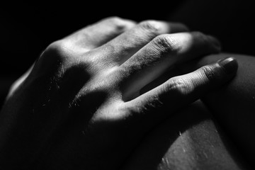 Poster - Grayscale closeup shot of a person's hand on a blurred background