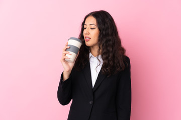 Wall Mural - Mixed race business woman holding coffee to take away over isolated pink background