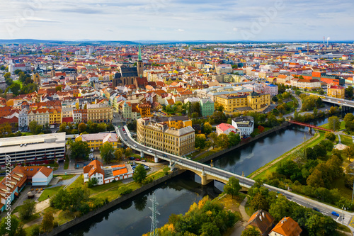 Fotomural Picturesque aerial view of old buildings of Pilsen cityscape with river and pond
