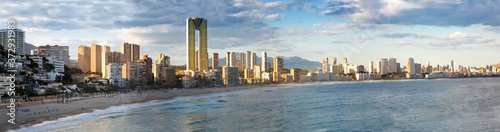 Fotomural sunny sandy beaches of Benidorm with modern housing and mountains on background