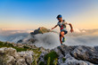 Man ultramarathon runner in the mountains he trains at sunset