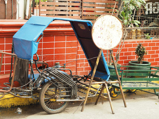 Wall Mural - Wheel carrier with metal instruments and weathered tools at a backyard