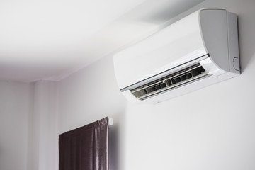 Air conditioner on white wall room interior background